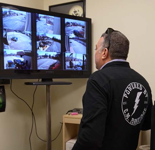 C.M. Armitage worker looking at security monitors